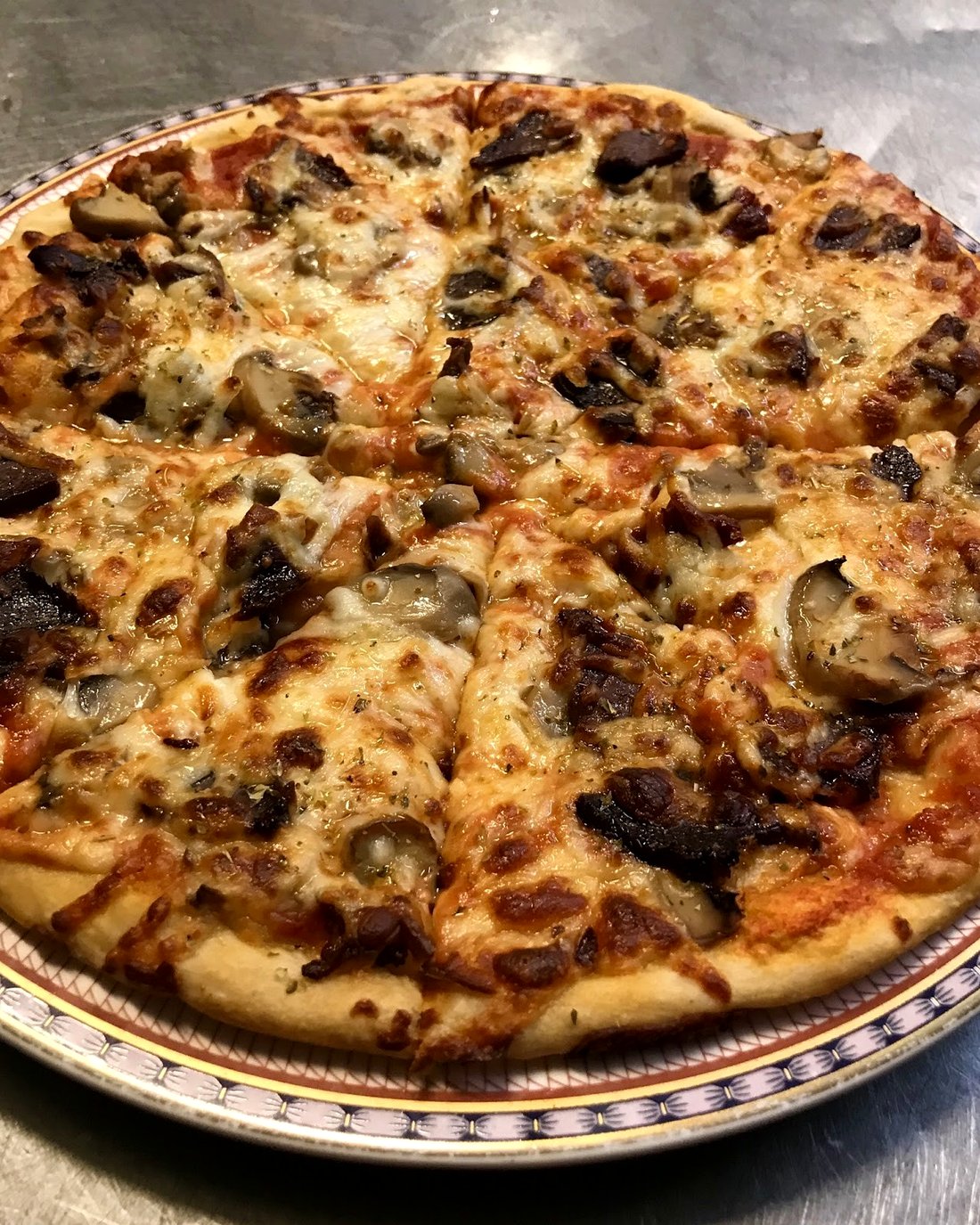 Close-up of a mushroom and meat pizza, fresh from the oven